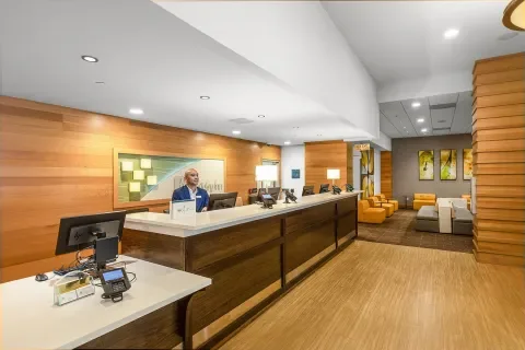 front desk showing three check in stations and lowered ADA accessible counter