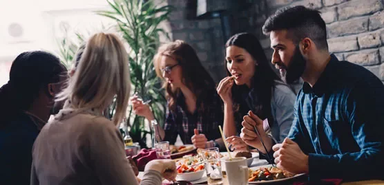 group of people sitting around a table enjoying a meal