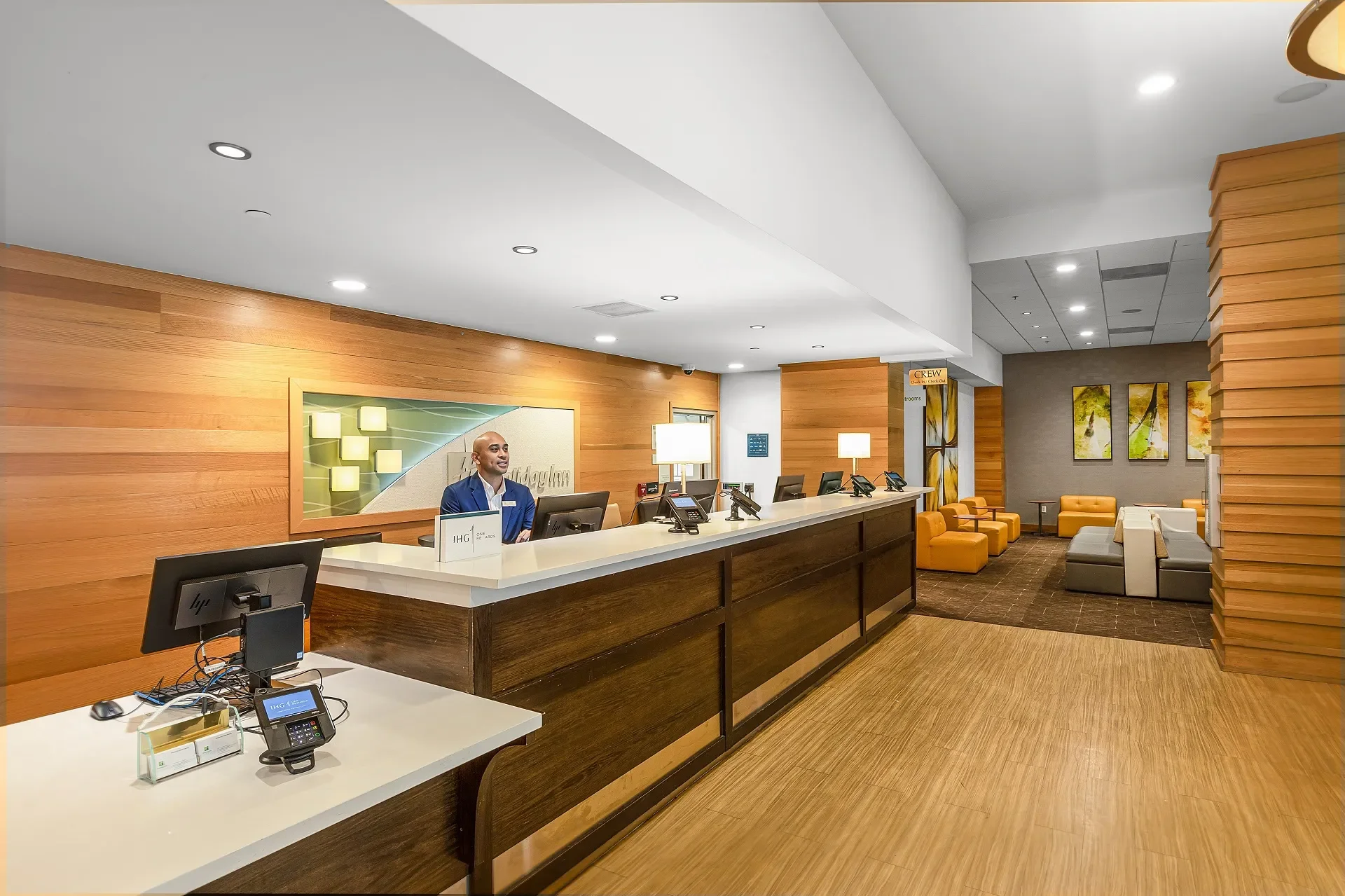 front desk showing three check in stations and lowered ADA accessible counter